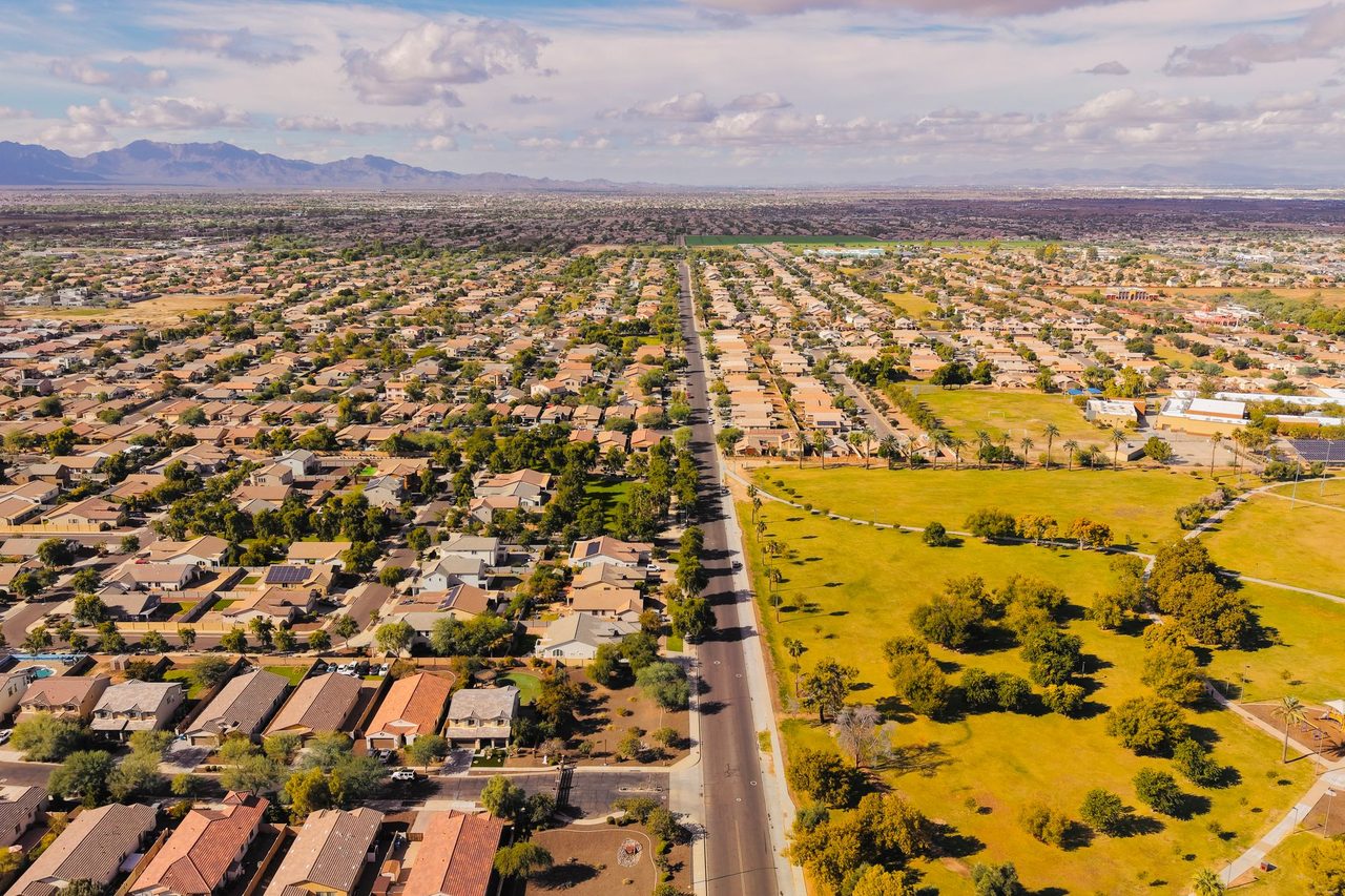 An aerial view of a suburban neighbourhood in Arizona with mountains on the horizon